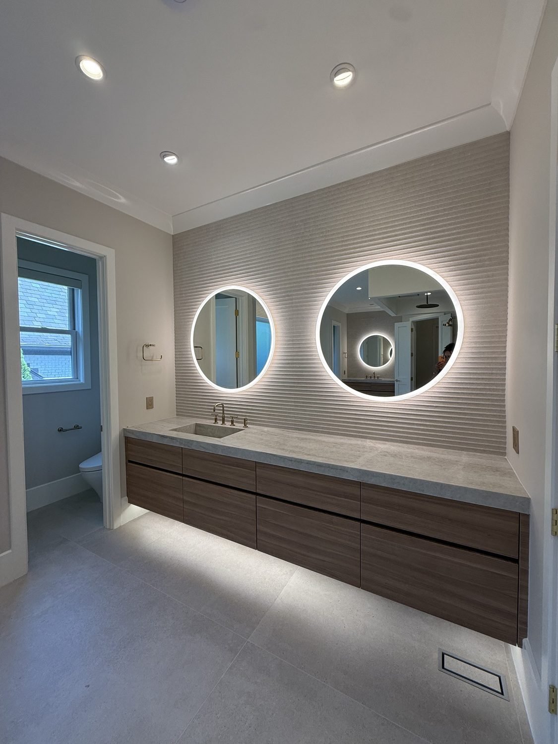 Floating Vanity with Backlit Mirrors